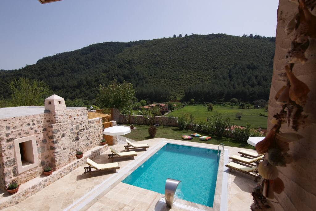 Your suite is overlooking the pool (shared) and lush green hills.
