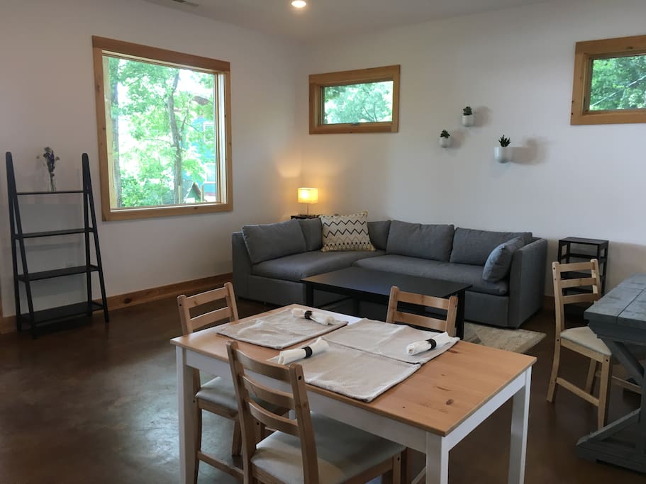 Large picturesque windows with views of the wooded area.