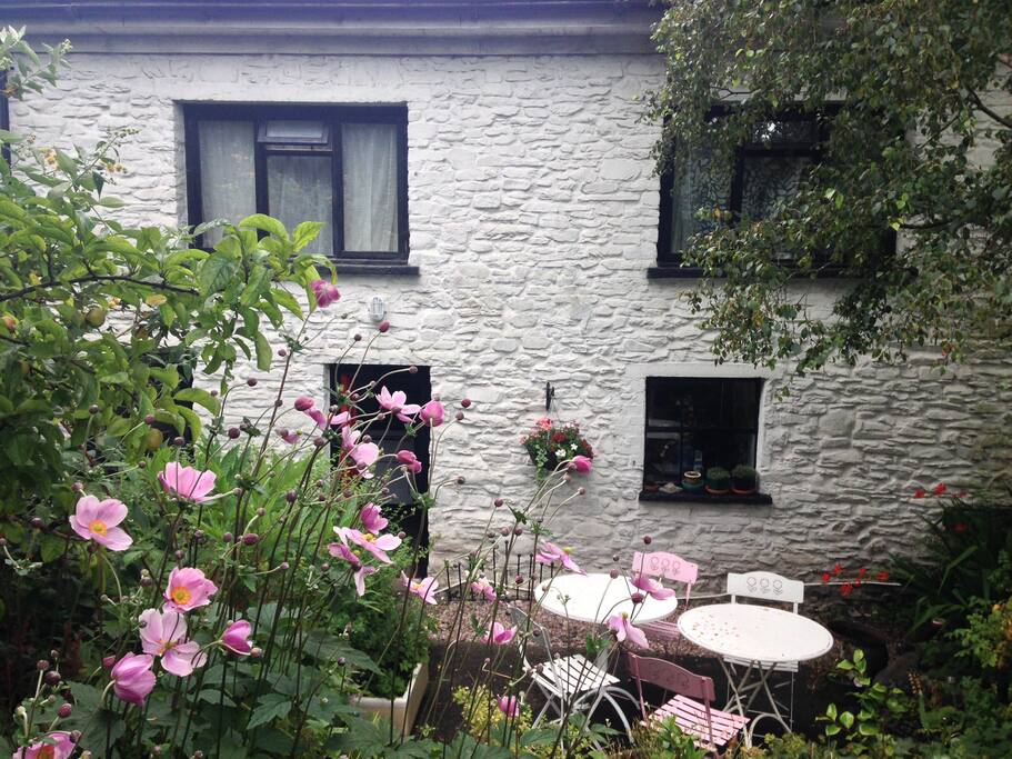 Back of the cottage in summer with garden tables and chairs