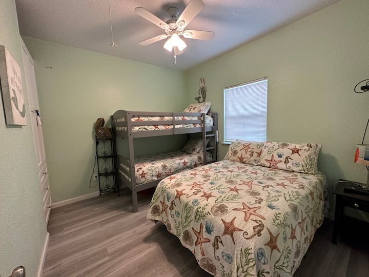 secondary bedroom with full size bed and two twins