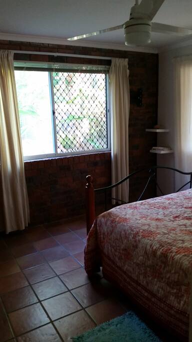 Bedroom with Queen bed. Listen to the birds and the surf.