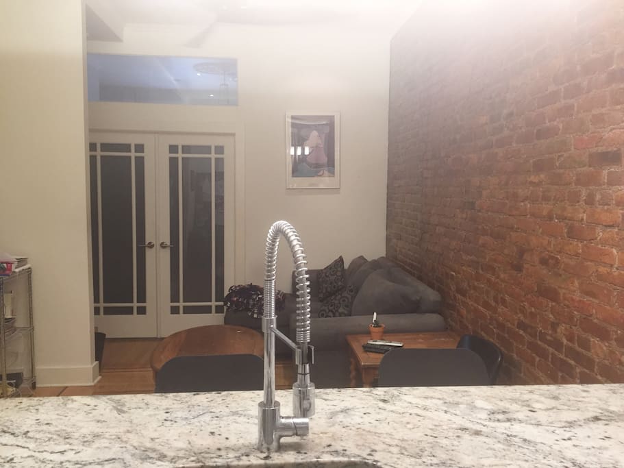 View from kitchen into living room, TV hidden in frame but on left wall
