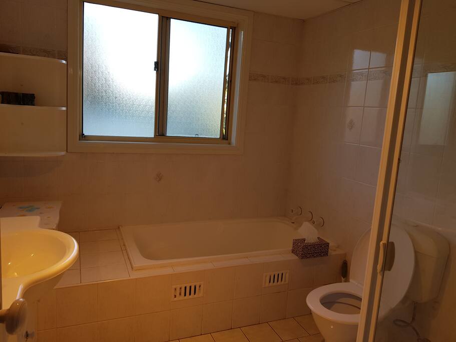 Main Bathroom with Bathtub and toilet with handshower