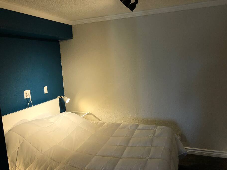 Queen bed with memory foam mattress. Sconces on either side of the bed + overhead track lighting.