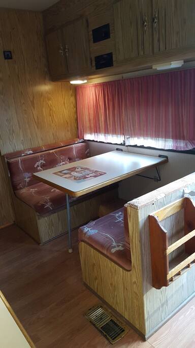 Eating area and table folds down to make a bed.