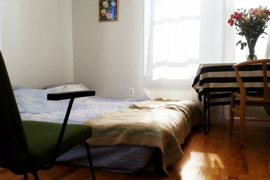 a small desk and a very big bed!