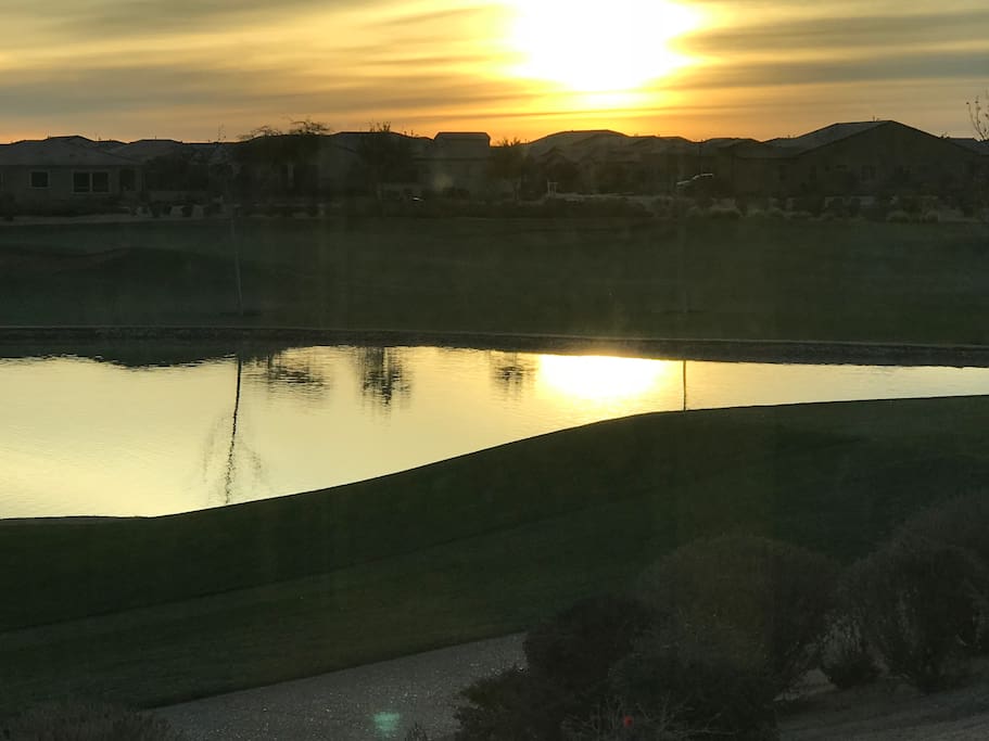 Sunrise over pond on golf course.