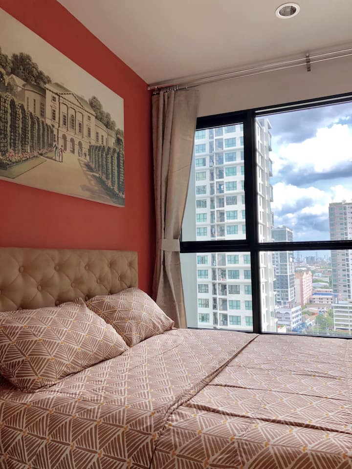 Bedroom with comfortable queen size bed, bedding, wardrobe and air-conditioner