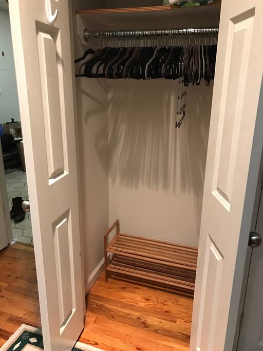 Double door closet in bedroom, with hangers and shoe shelf for use!