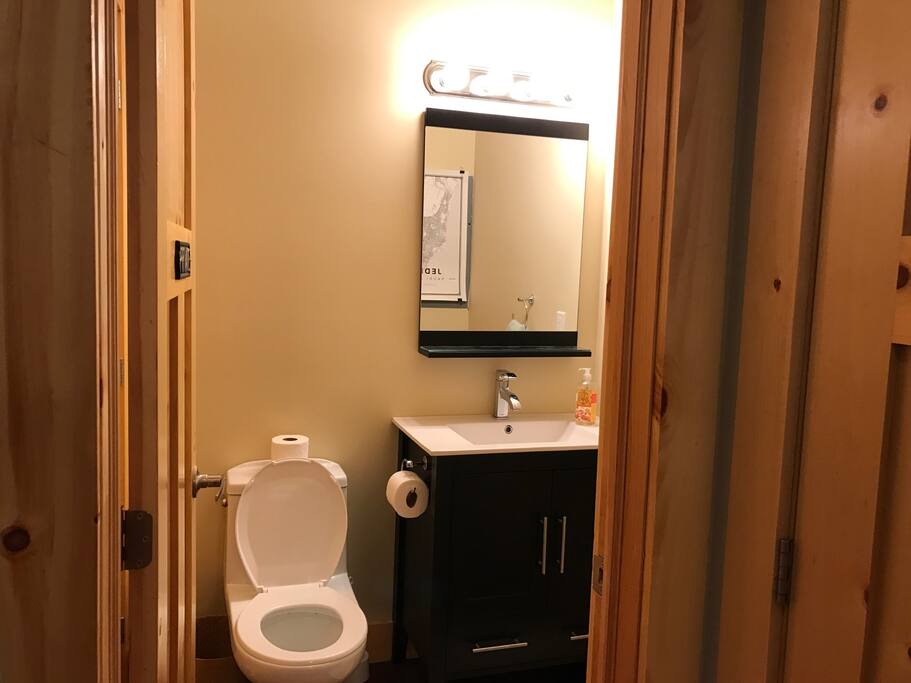 Studio-style lighting in the half bathroom. The stacked washer/dryer is tucked away to the left!