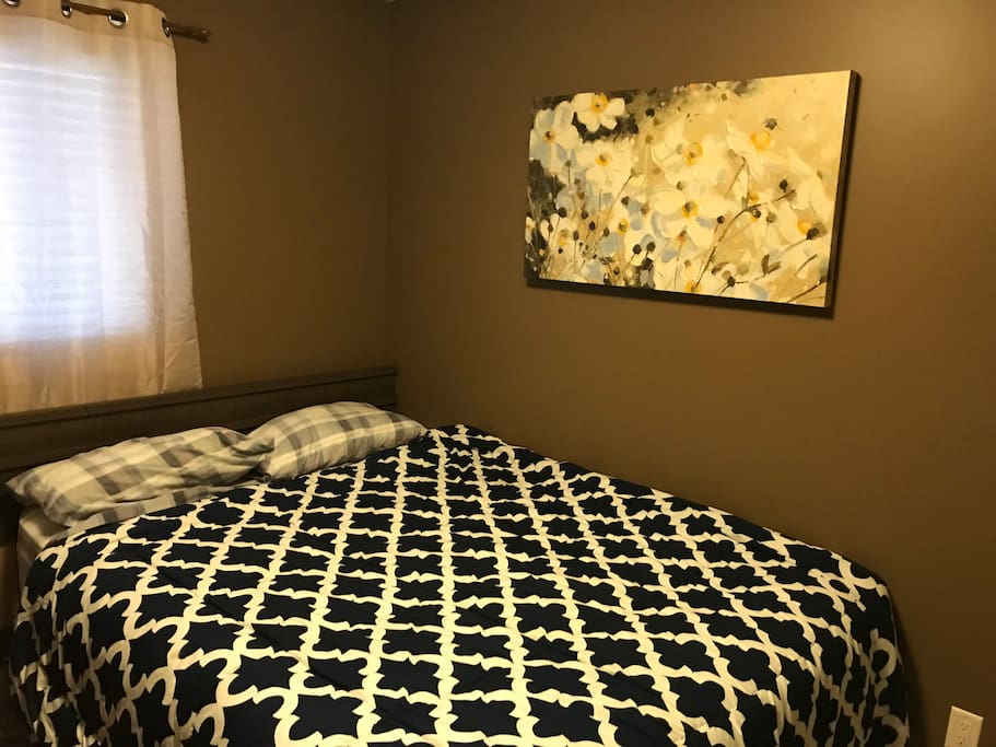 cozy bedroom with queen bed for up to 2 guest. Netflix available on wall-mounted TV
