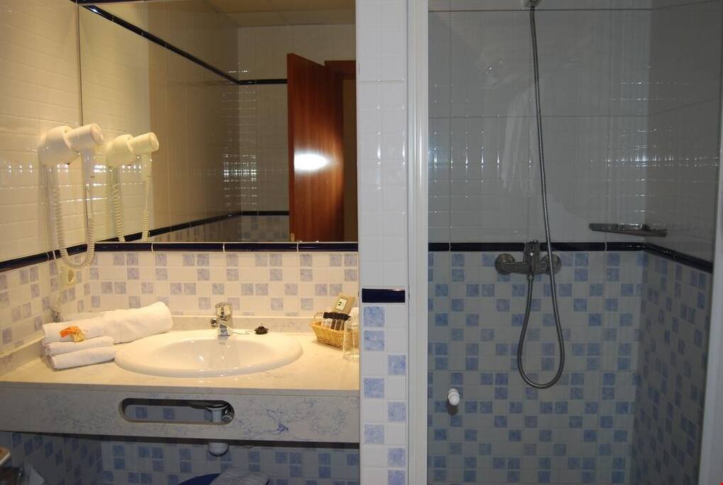 The bathroom comes equipped with a hair dryer and towels.