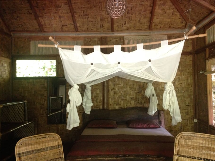 King-size bed with mosquito net