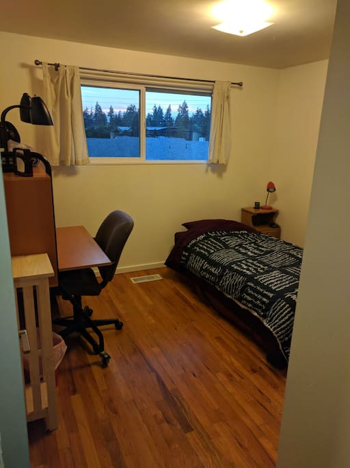 Nice, basic bedroom with single bed, versatile desk, chair & west facing window.