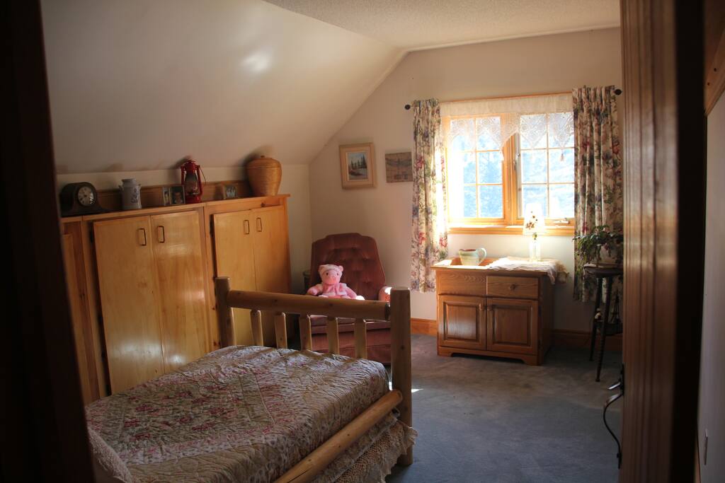 cozy bedroom with a view of the deer in the yard