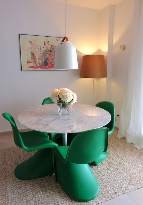 Living room with a marble table and four designer chairs