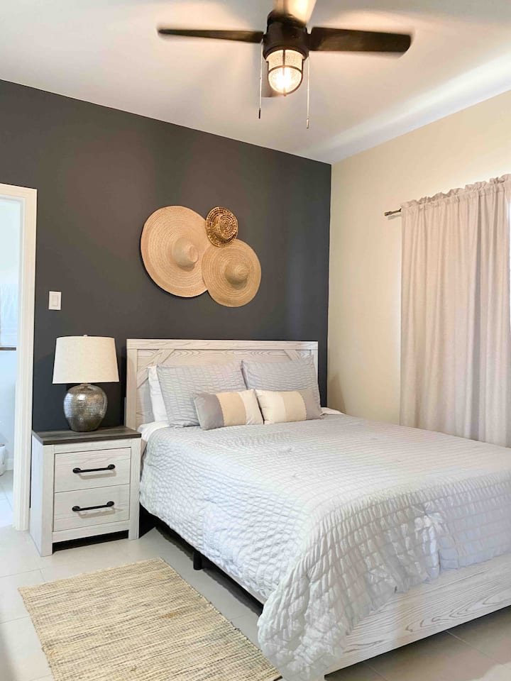 Queen bed in Master bedroom with blackout curtains.