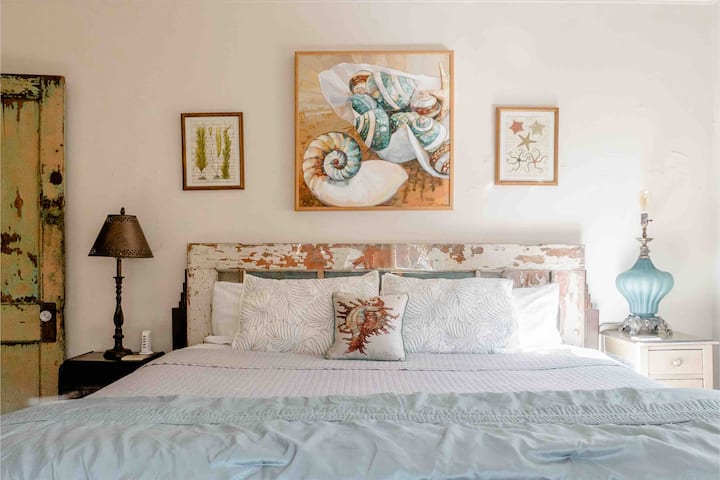 The headboard is custom made from a door original to the Loft