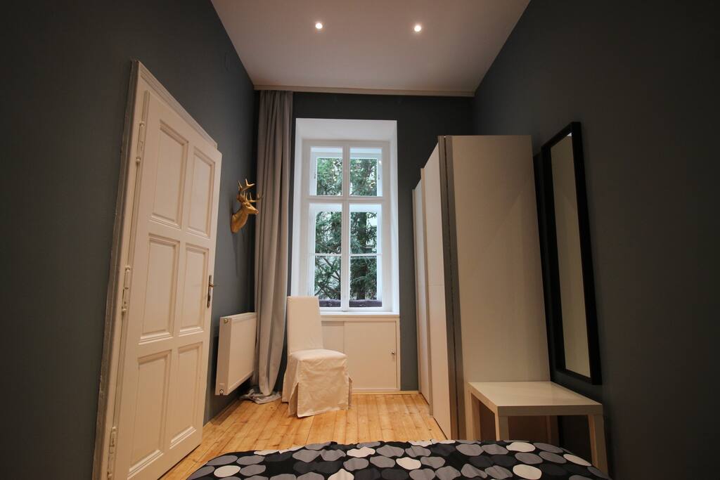 Bedroom with wardrobe and dressing mirror.