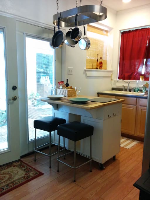 Moveable dining table also serves as a prep table and storage unit.