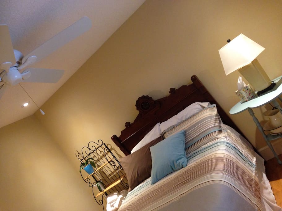 Antique full size bed in room with awesome closet space.