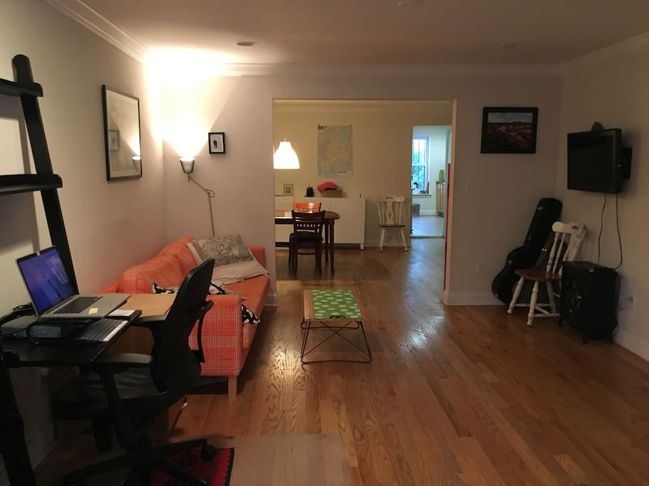 View from living room into dining room into kitchen into backyard