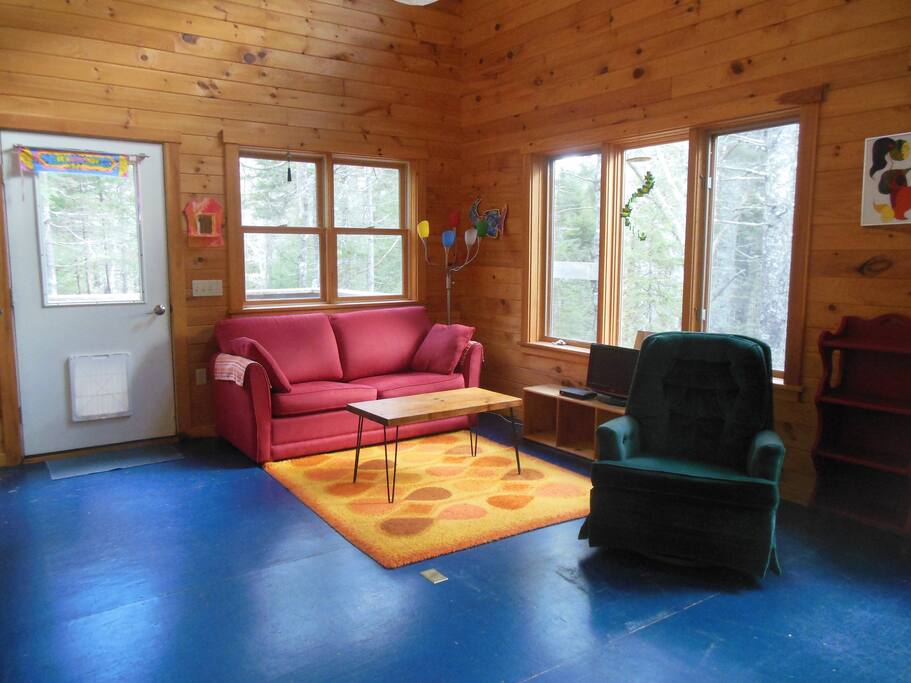 Sunny living room looking out over the forest.
