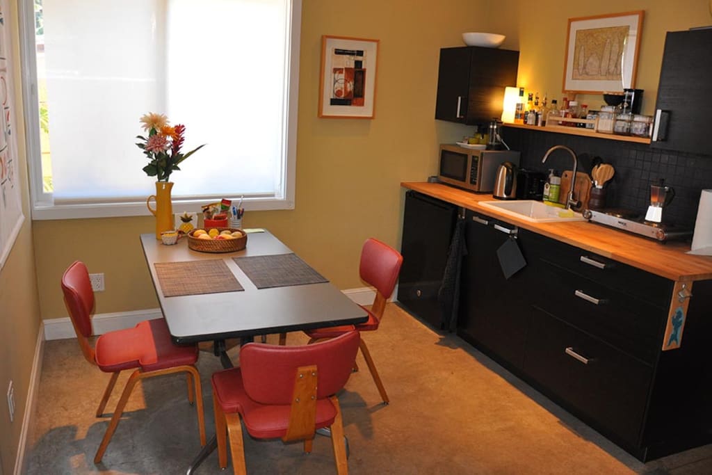 Cozy kitchen and dining.
Simple galley-style kitchen with stove top, microwave, electric kettle and small under-counter refrigerator. Stocked with basics - tea, coffee, milk, breakfast needs, herbs + spices, olive oil, etc.