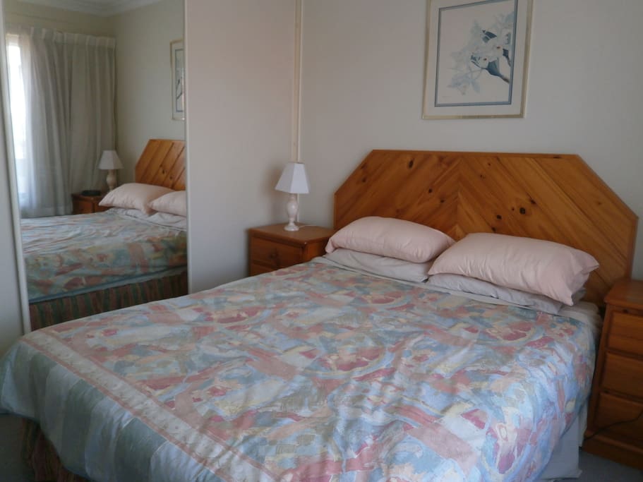 Main bedroom, mirrored wardrobes, clock radio alarm