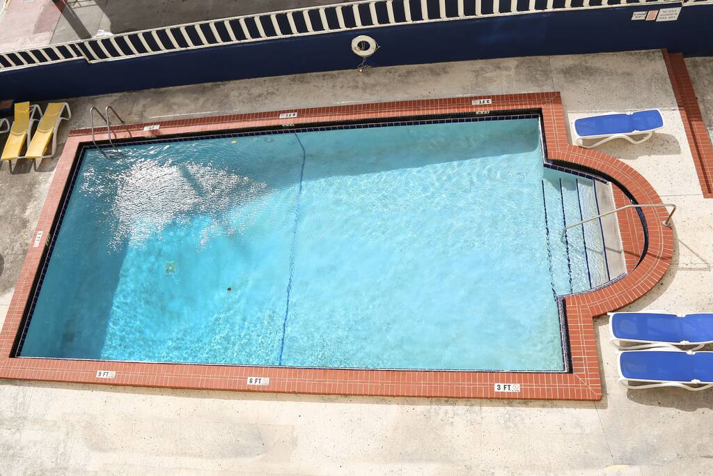 Large pool - 3 ft to 9 ft deep. Pool is approx. 6 ft above street level