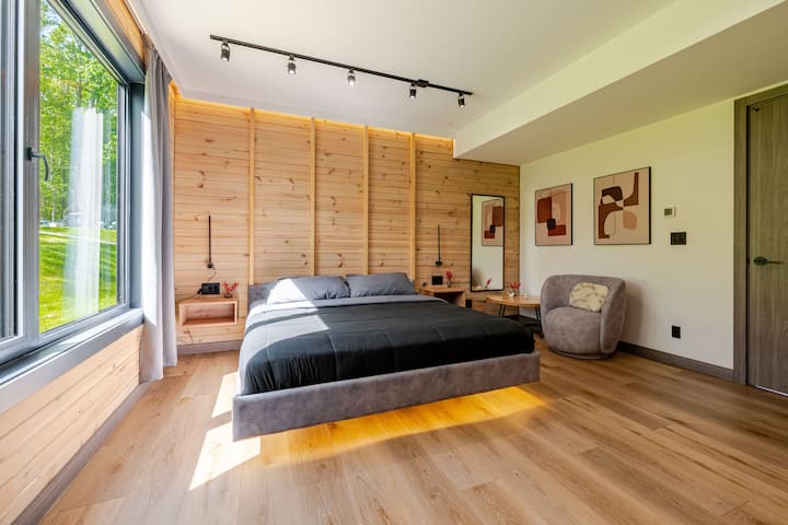 Bedroom 5 is a ground floor primary suite with a king-size bed, offering convenience and easy access to the main living areas.