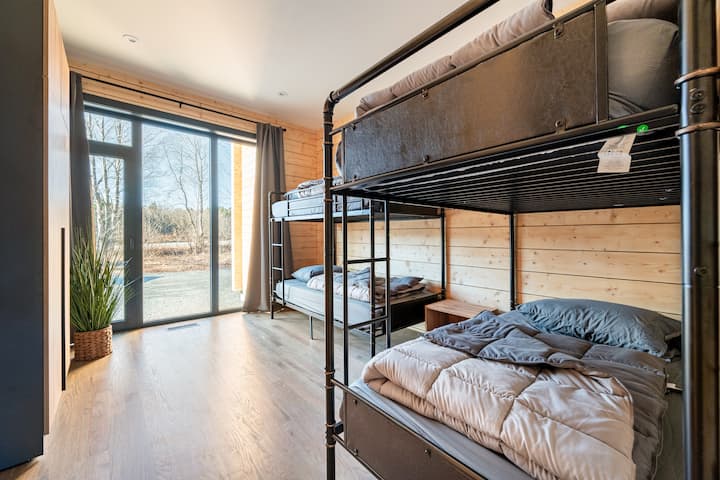 Luxury Redefined: Master suite featuring a plush king-sized bed, designed for ultimate relaxation and comfort, complemented by a spacious double-sink bathroom.