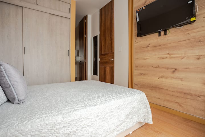 غرفة واسعة ومشرقة، مع خزانة كبيرة ومرآة كبيرة وتفاصيل مليئة بالأناقة والفرح.