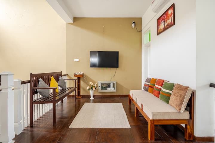 A vibrant and spacious living area designed Gather with your group on the large divan beds, sing along to your favourite tunes, dance, and enjoy movie nights on a stunning 54-inch TV. The perfect space to relax, bond, and create lasting memories.