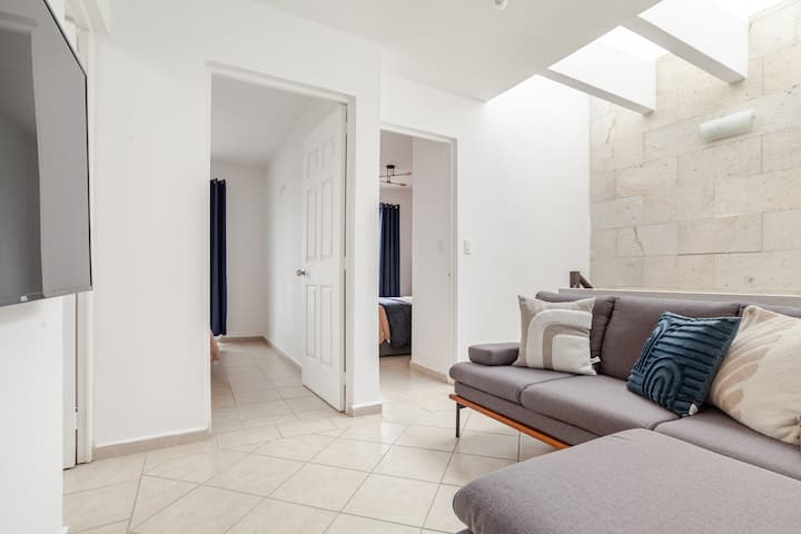 Salon à l'étage avec Smart TV 55 pouces et canapé-lit double.