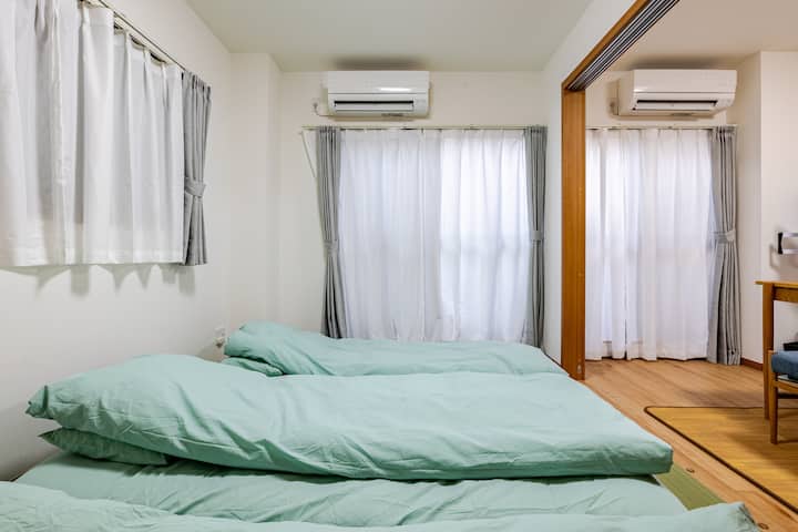 In the Japanese tatami room, behind this curtain is a Japanese backyard. To the right of this room is a dining area separated by a sliding door.