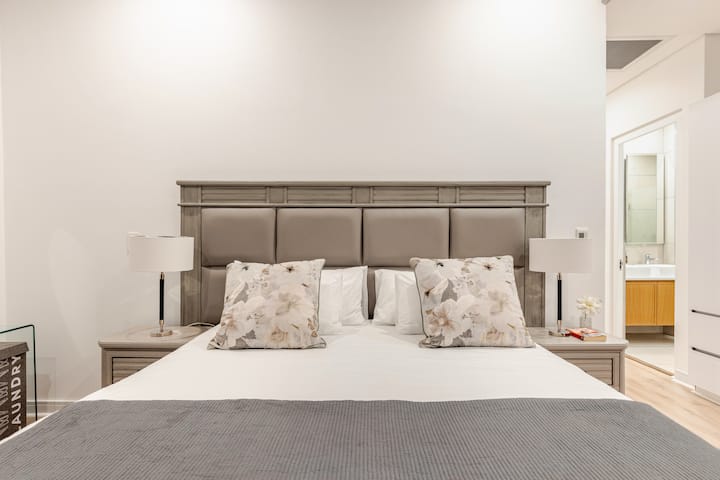 The master bedroom features a comfortable King XL bed with fresh, high-quality linens, plush pillows, and cozy bedding. 
Extra towels, bedding, a hairdryer, and a safe are provided in the cupboard. 
Relax, unwind, and feel right at home!