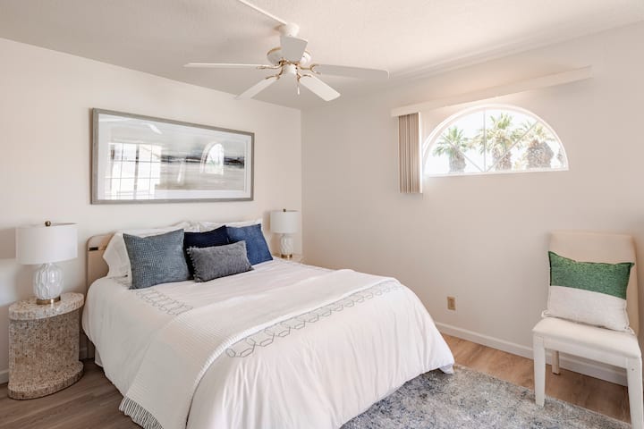 The secondary bedroom includes a comfortable queen size bed and ceiling fan for additional comfort.