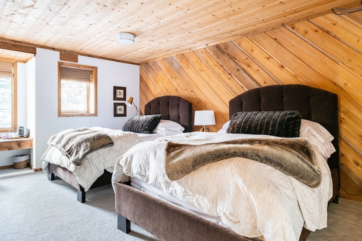 Bedroom 4 on the bottom floor, with two double beds and a vanity area.