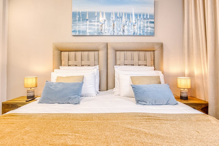 Comfortable bedroom with flexible king or twin setup, blackout shutters and 50 inch TV for a relaxing stay
