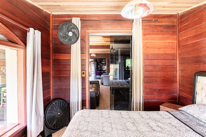 Room 1 with fans and views of the front of the house (a queen bed)