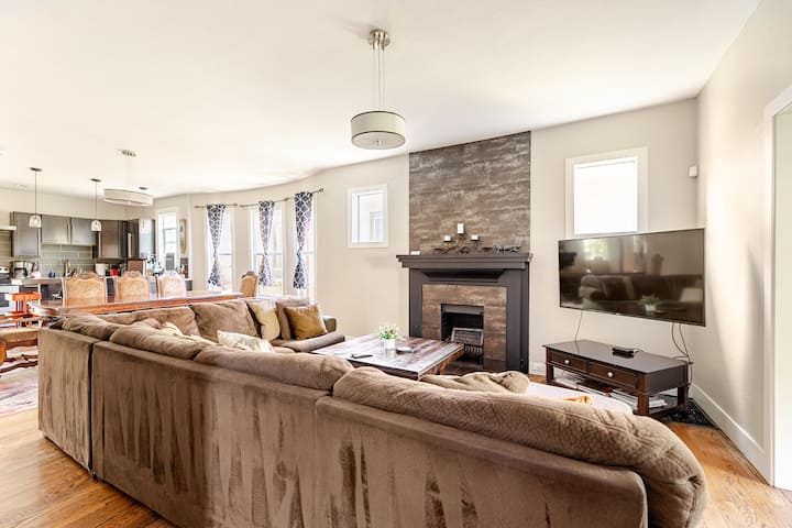 Large living room with comfy couch and TV