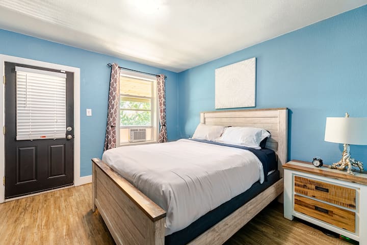 Upstairs bedroom with queen bed and direct access to the second floor patio