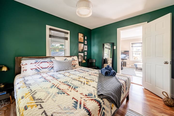 Cozy king bed with AC, heat, and a nightstand with lamp—perfect for restful sleep in any season