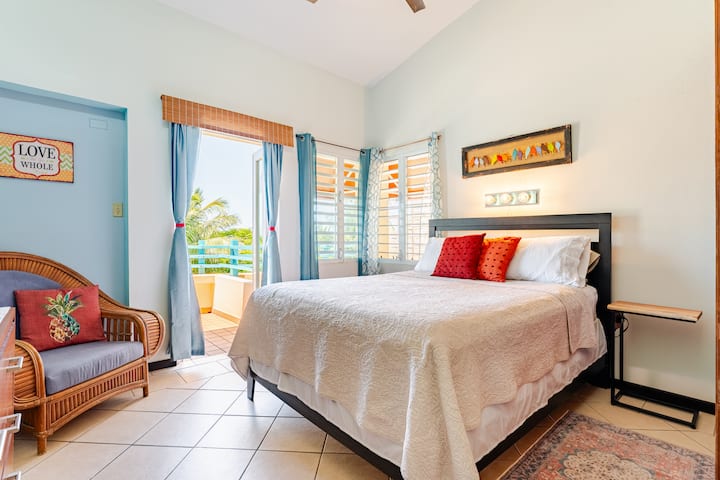 Picture taken from hallway looking into the bedroom. Double glass doors open from bedroom onto large oceanfacing balcony that you may also access via living room