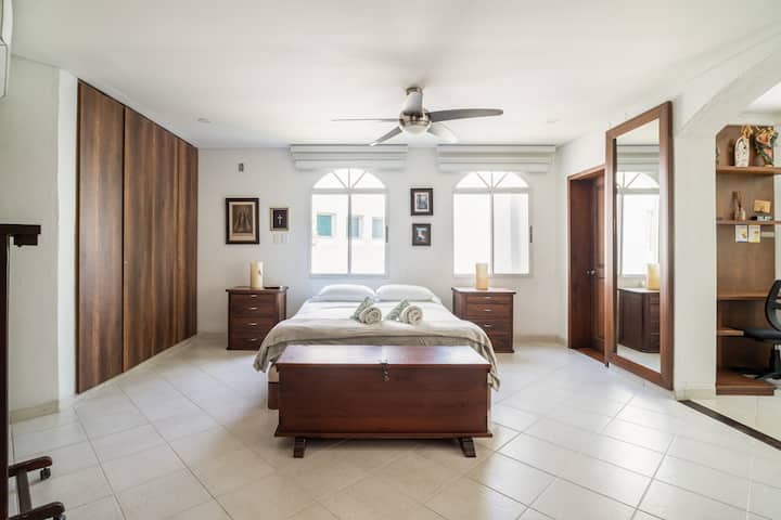 Master bedroom with double bed and private bathroom.