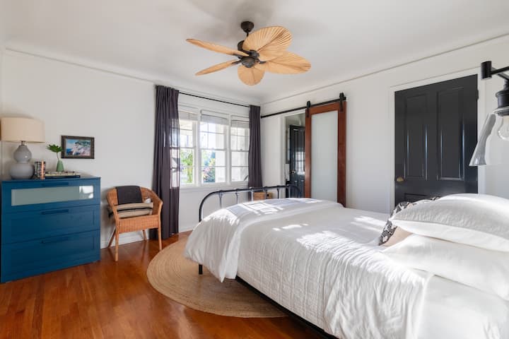 ห้องนอนนี้มีเตียงควีนไซส์ตู้เสื้อผ้าและตู้เสื้อผ้า ห้องน้ำในตัวอยู่ทางประตูริมหน้าต่าง