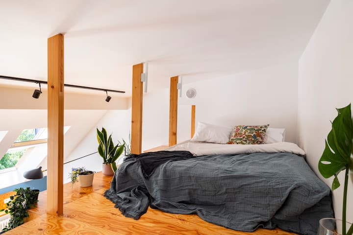 The second bed is on a cozy mezzanine, accessible by a ladder. It's 150cm wide with a convenient outlet next to the bed for charging your phone. While the living room's shades are partly transparent, the space can be completely dark only at night.