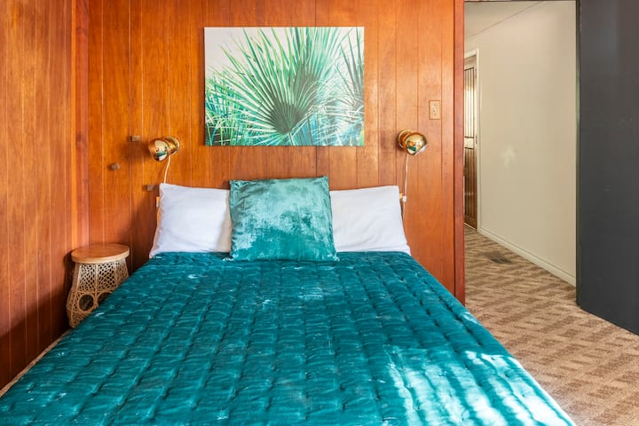 Bedroom #1 Comfortable queen bed with 3" foam mattress topper. Floor fan provided for air circulation.
