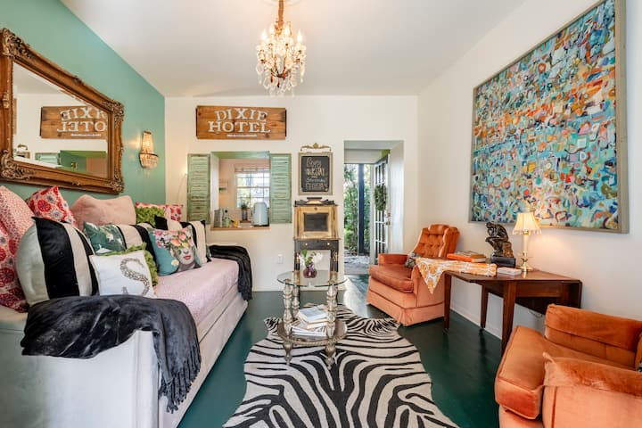 Living room space with desk and smart tv and daybed for relaxing